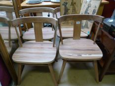 A Set of four light wood dining chairs