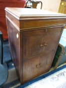 An oak music cabinet with record player inside