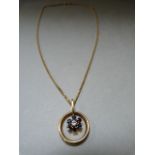 An 18ct gold pendant set with single Diamond and six Sapphires on an 18ct gold chain