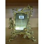 An ornate brass photo frame marked "Harcourt" with registration number