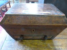 A sarcophagus shaped casket with drawer under