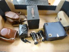 Box of vintage cameras and a pair of opera glasses