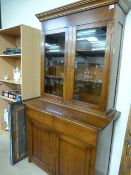 Tall mahogany bookcase with cupboards and drawer under