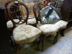 A set of six walnut balloon back chairs on cabriole legs