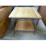 An iron framed table with a pine top