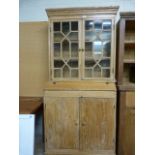 An antique pine dresser with 2 cupboards under and glazed doors above.