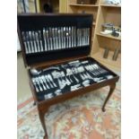 A leather inset cutlery cabinet containing part set of silverplated cutlery