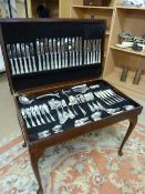 A leather inset cutlery cabinet containing part set of silverplated cutlery