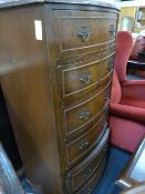 A bow fronted chest of six drawers