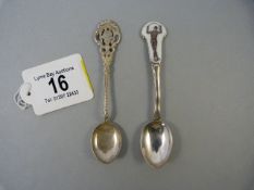 A continental hallmarked silver teaspoon and an enamelled topped silver teaspoon - depicting a