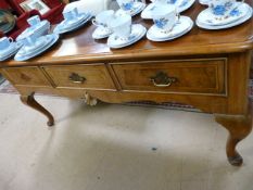 A walnut dresser base with three drawers on cabriole legs