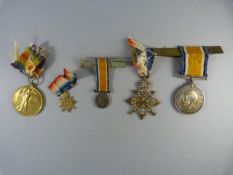 A set of three WWI medals, along with two miniatures presented to Captain T.W Reynolds (and later