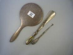 A hallmarked silver handled pin hook and shoe horn and a hallmarked silver dressing table mirror