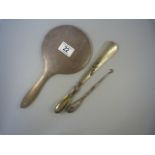 A hallmarked silver handled pin hook and shoe horn and a hallmarked silver dressing table mirror
