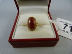 A cabochon garnet ring set in 9 ct gold