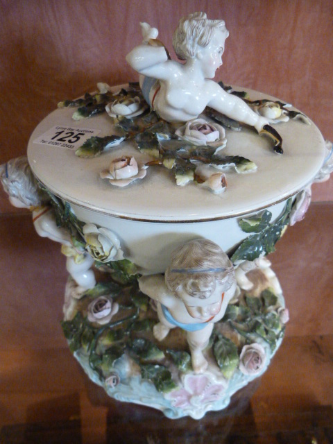 A floral and cherub encrusted jar and cover, possibly Sitzendorf-A/F