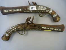 A pair of flintlock pistols inlaid with mother of pearl - dated 1875