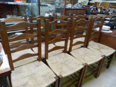 A set of eight oak ladder back chairs