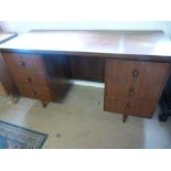 A Mid- Century kneehole desk with three drawers either side