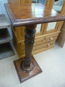 A Mahogany plant stand on carved stem