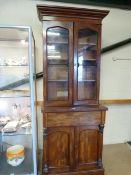 A Victorian mahogany bookcase with cupboard under