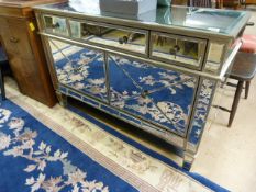 A Mirrored sideboard with three drawers over and two under