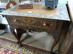 An antique oak low boy on cabriole legs