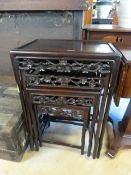 A nest of 4 Chinese hardwood tables with carved frieze