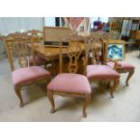 A large teak dining room table and 8 chairs