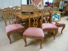 A large teak dining room table and 8 chairs