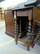 An oak drop leaf table on barley twist legs