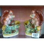 A pair of Staffordshire spill vases in the form of squirrels