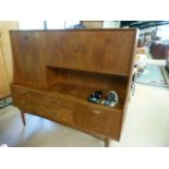 A Mid century sideboard with cupboards and drawers under