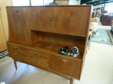 A Mid century sideboard with cupboards and drawers under