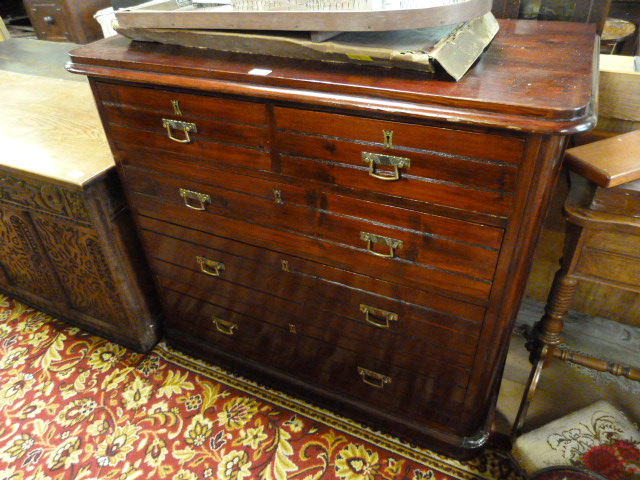 A stained pine chest of drawers