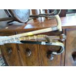 A quantity of walking sticks, 2 hallmarked silver banded