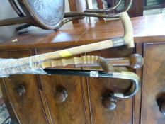 A quantity of walking sticks, 2 hallmarked silver banded