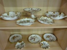 A dessert set by Royal Worcester, consisting of a comport, 6 plates, two small shell shaped