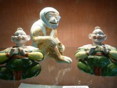 A porcelain monkey figure along with a pair of seated Oriental style nodding figures (1 A/F)