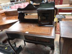 An ornate ladies writing desk on cabriole legs