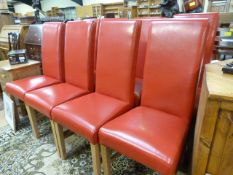 A set of eight red leather dining room chairs