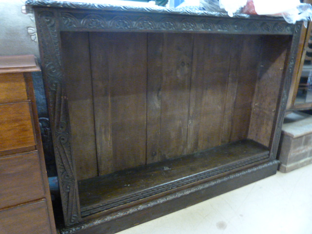 A large oak bookcase with carved decoration