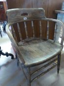 An oak captain style chair with carved decoration to back