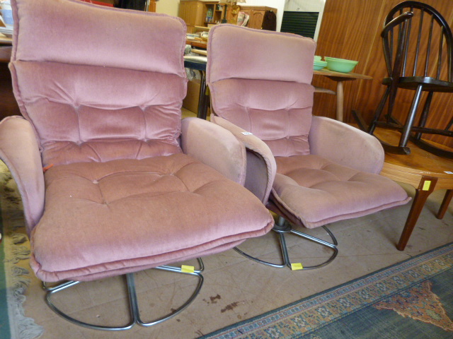 A Pair of pink mid century swivel chairs
