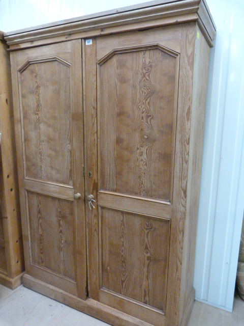 A pine wardrobe/cupboard- key in office