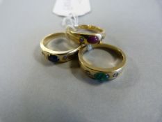 A trio of 14 carat gold rings set with Sapphire, Ruby & Emerald each with diamond shoulders. Total