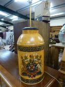 A Metal tea canister decorated with armorial converted to a lamp