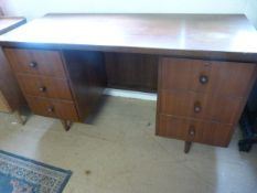 A Mid- Century kneehole desk with three drawers either side