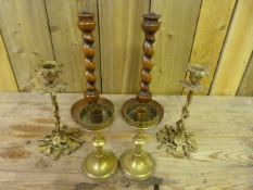 A Pair of turned wooden candlesticks and two pairs of brass ones