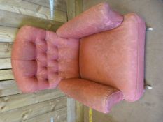 A Re-upholstered armchair on oak legs